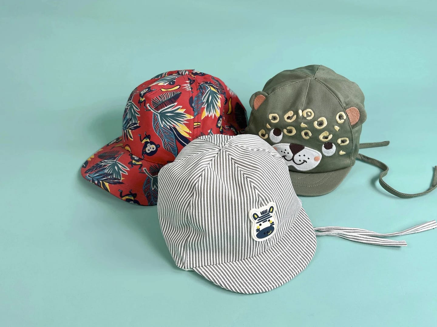 A fun display of children's hats featuring playful designs, representing Dpam