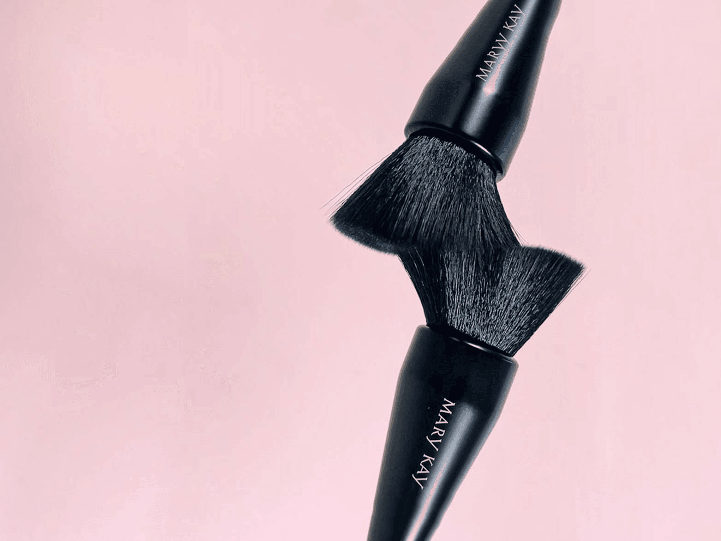A close-up of a makeup brush set, showcasing Mary Kay products